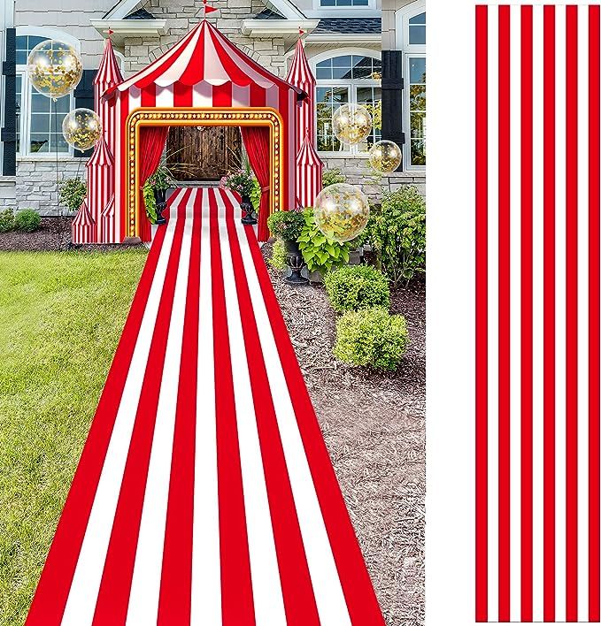 a large red and white striped rug in front of a house