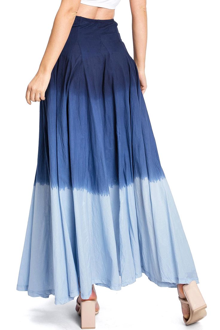 Stunning maxi skirt with a vibrant dipped dye, ombre wash and pleated construction at the top. Convertible style can be worn as a skirt or pulled up and worn as a dress. Additionally, adjustable ties on the underside can be tied together to create a fuller look! CARE | Hand Wash Cold CONTENTS | 100% Cotton MEASUREMENTS | 40"/102 cm Top to Bottom (Size Small) MODEL | 5'8 - wearing a size Small IMPORTED Ombre Maxi Skirt, Blue Non-stretch Tiered Maxi Skirt, High-waisted Denim Blue Cotton Maxi Skirt, Convertible Skirt, Casual Tie-dye Beach Skirt, Blue Non-stretch Bohemian Maxi Skirt, Washed Ashore, Full Look, A Dress