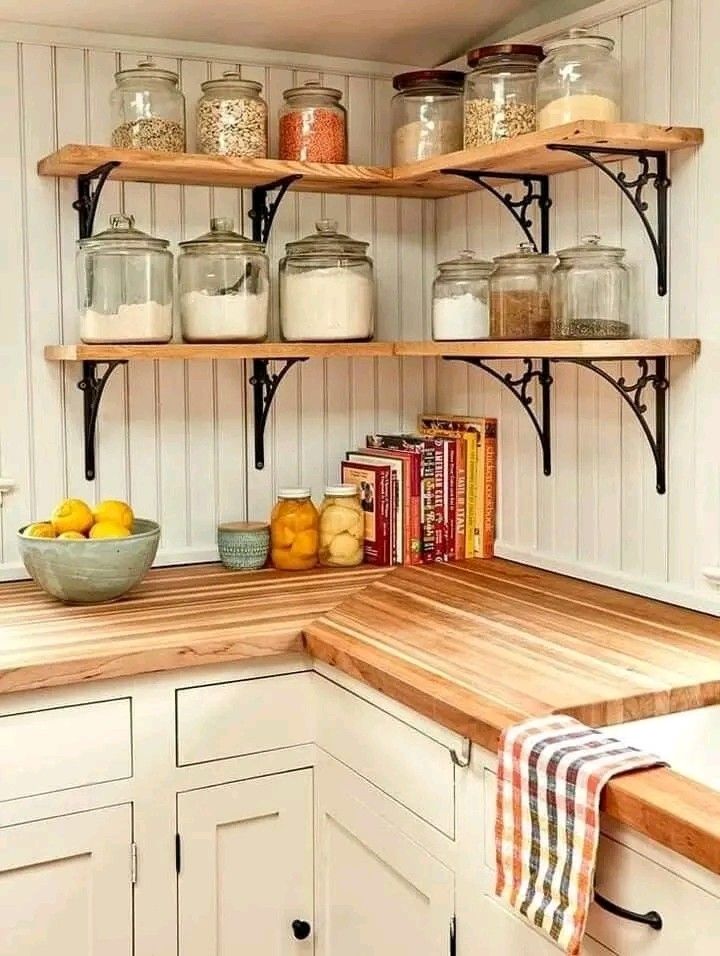 a kitchen with shelves filled with jars and lemons