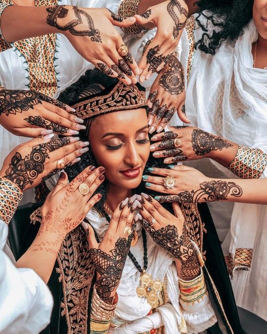 a group of women with henna tattoos on their hands