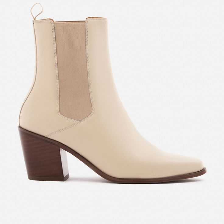 A unique Chelsea boot. Inspired by cowboy boots and western styling, the Bianca Chelsea Boots kick things up a few notches. The semi square toe box, alluring Cuban heel and sculptural shape create a captivating silhouette that will attract the right kind of attention. With a contemporary look and feel, the Biancas love to have fun, and play well with your casual outfits and dressy ensembles. Go ahead, take them for a whirl. This product is made from Gold Rated full-grain calfskin leather sourced Western Block Heel Boots For Fall, Western Mid-calf Boots With Stacked Block Heel, Western Boots With Sculpted Heel For Fall, Western Style Mid-calf Boots With Block Heel, Western Chelsea Boots With Square Toe For Fall, Beige Snip Toe Boots With Reinforced Heel, Fall Western Chelsea Boots With Square Toe, Chelsea Boots With Square Toe And Reinforced Heel, Western Chelsea Boots With Square Toe And Reinforced Heel