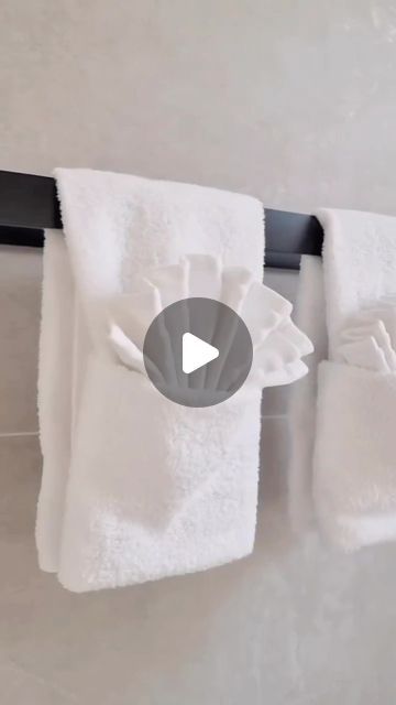 two white towels hanging on a towel rack