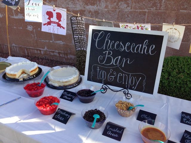 a table topped with cakes and desserts next to a sign