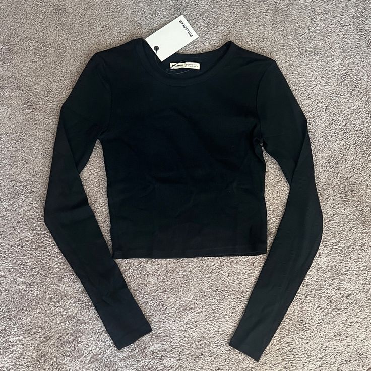 Pull&Bear Black Long Sleeve Crop Shirt Made In Bangladesh Size: Small 95% Cotton 5% Elastane Black Crew Neck Crop Top For Winter, Basic Black Tops For Fall, Casual Black Crop Top For Winter, Basic Long Sleeve Crop Top, Trendy Long Sleeve Black Top, Trendy Black Long Sleeve Top, Black Crop Top For Winter, Black Crew Neck Winter Crop Top, Casual Black Long Sleeve Crop Top