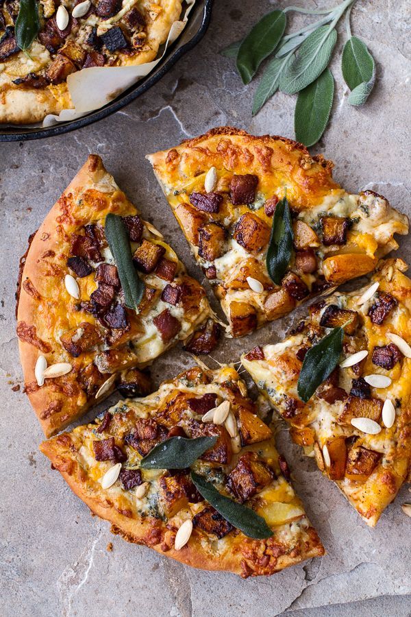 a pizza sitting on top of a table next to a pan filled with toppings