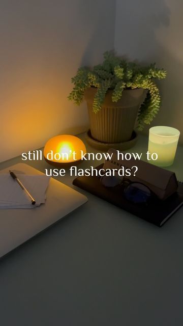 a desk with a notepad, pen and candle on it that says still don't know how to use flashcards?