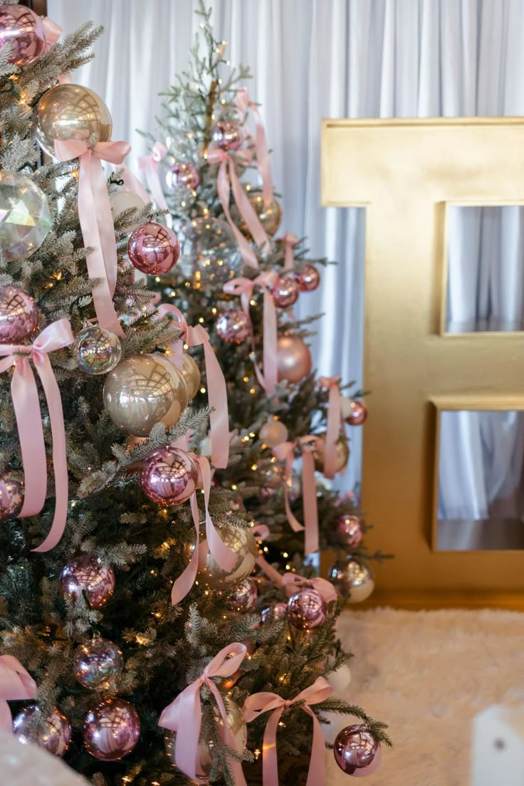 a decorated christmas tree with pink and gold ornaments