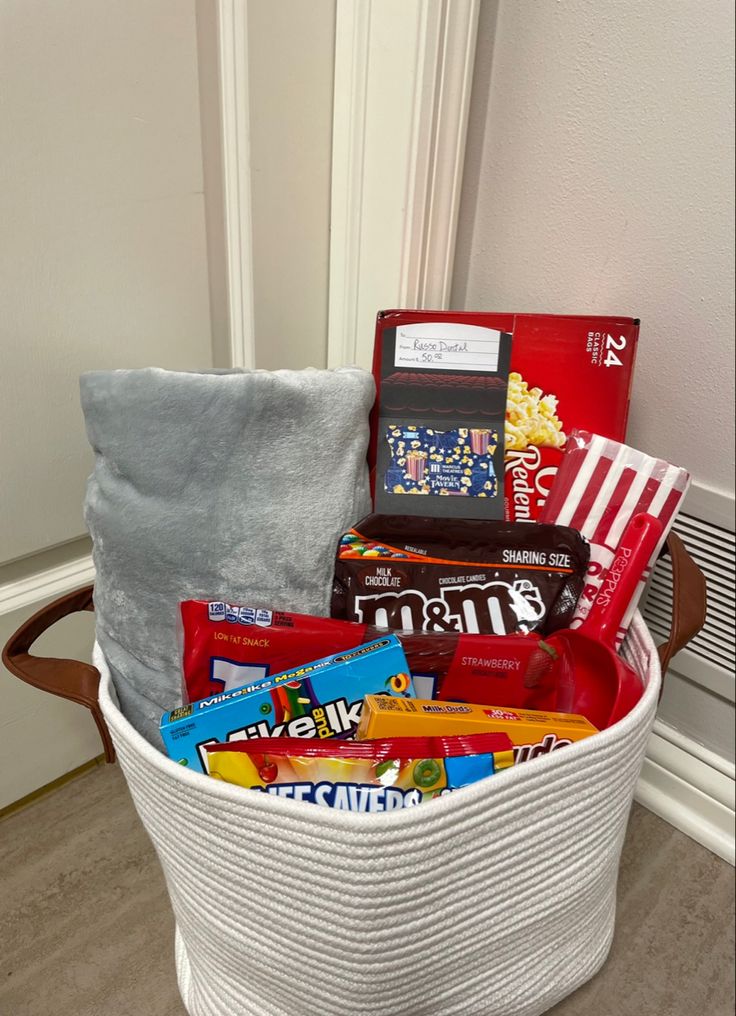 a white basket filled with candy and snacks