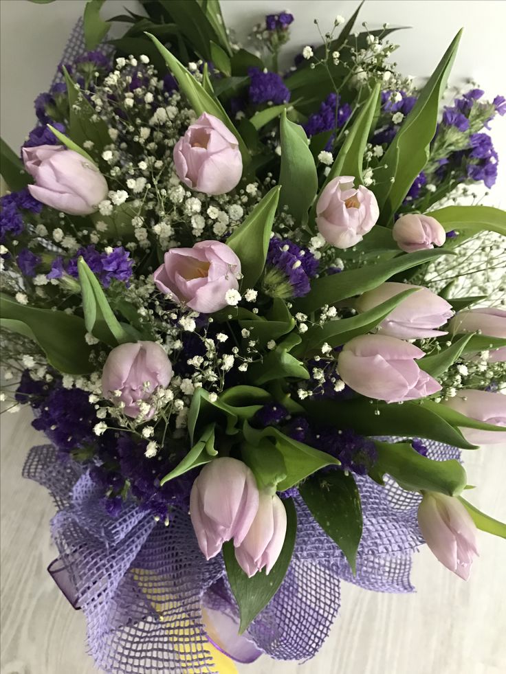 a bouquet of tulips and other flowers on a table