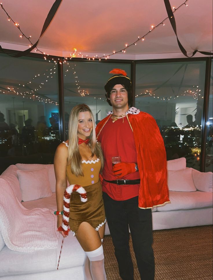 a man and woman dressed up in costumes posing for a photo at a christmas party