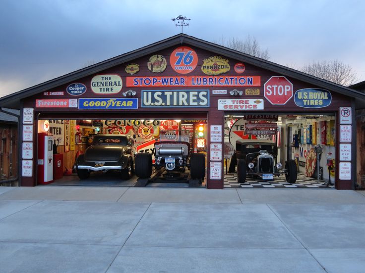 an outside view of a store with cars parked in the garage and on the street