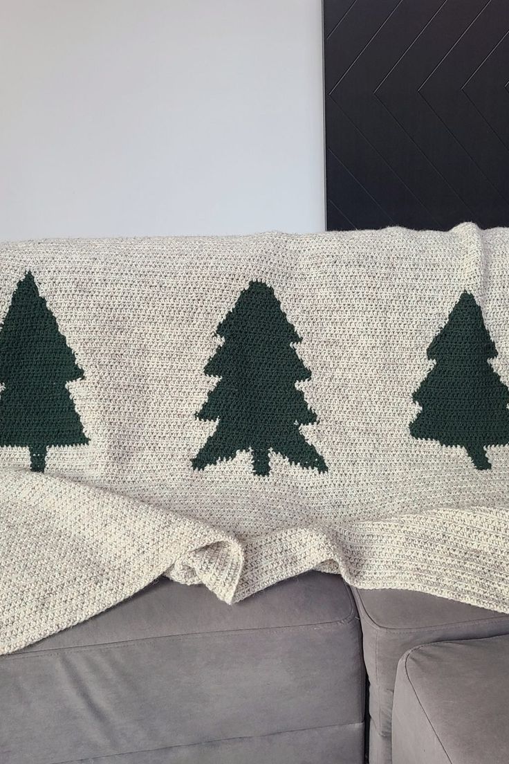 a crocheted christmas tree afghan on a couch