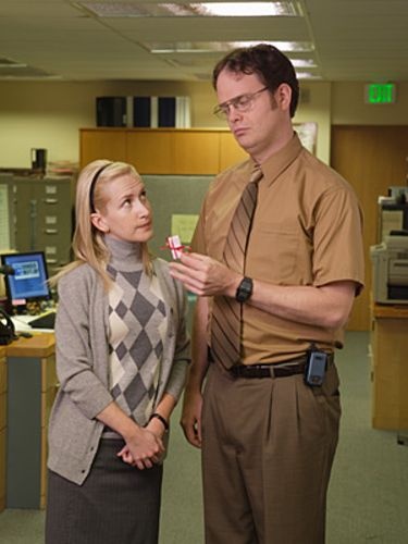 a man standing next to a woman in an office