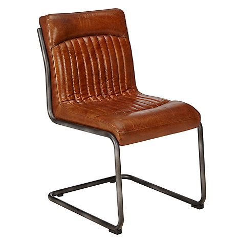 a brown leather chair sitting on top of a metal frame