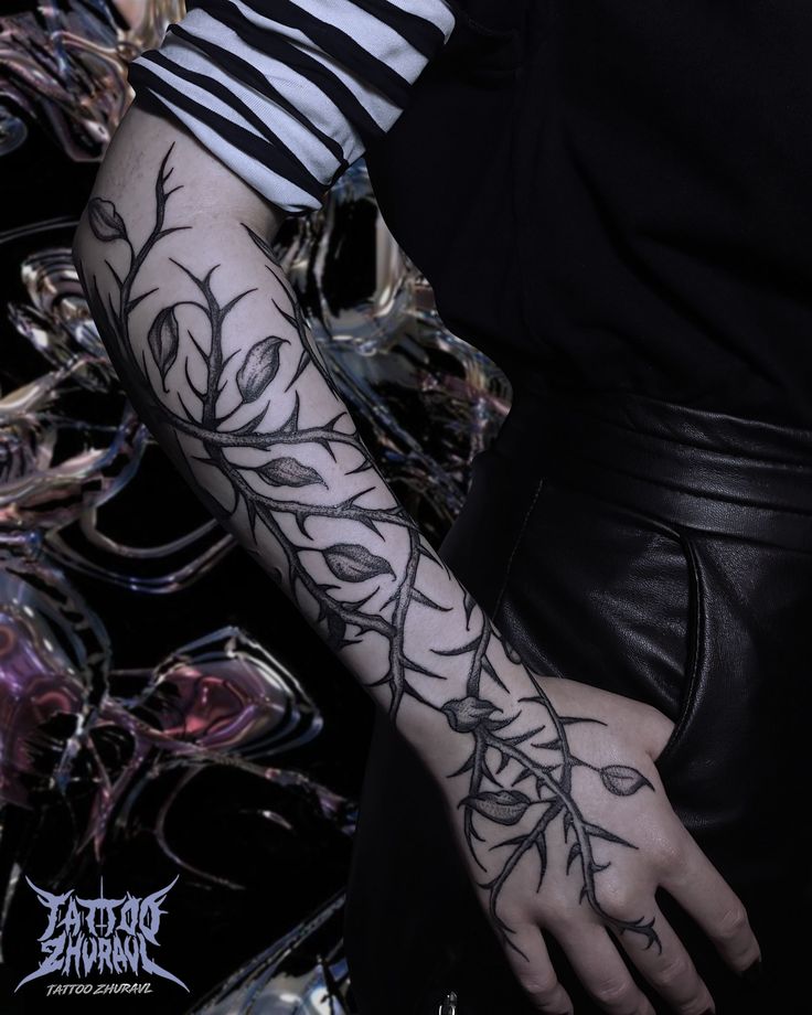 a woman with tattoos on her arm and hand