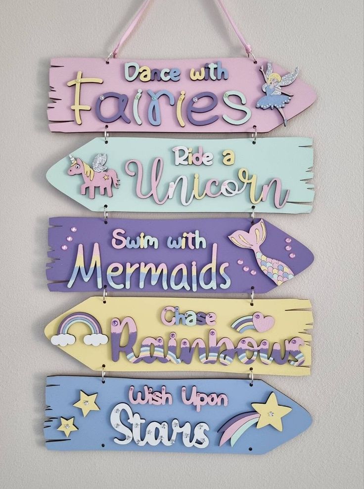 three wooden signs hanging on the wall with words written in different colors and designs,