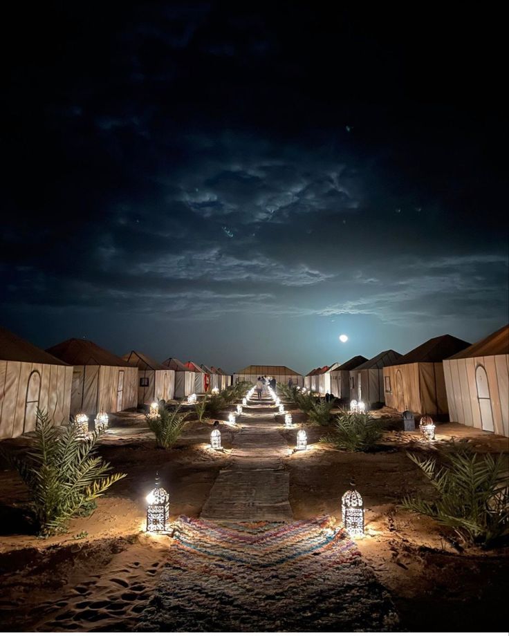 an outdoor pathway lit up at night with lights