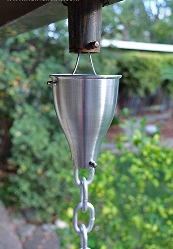 a bird feeder hanging from the side of a house