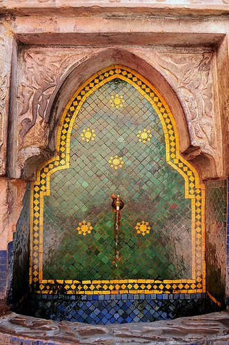 an ornate doorway with green and yellow tiles