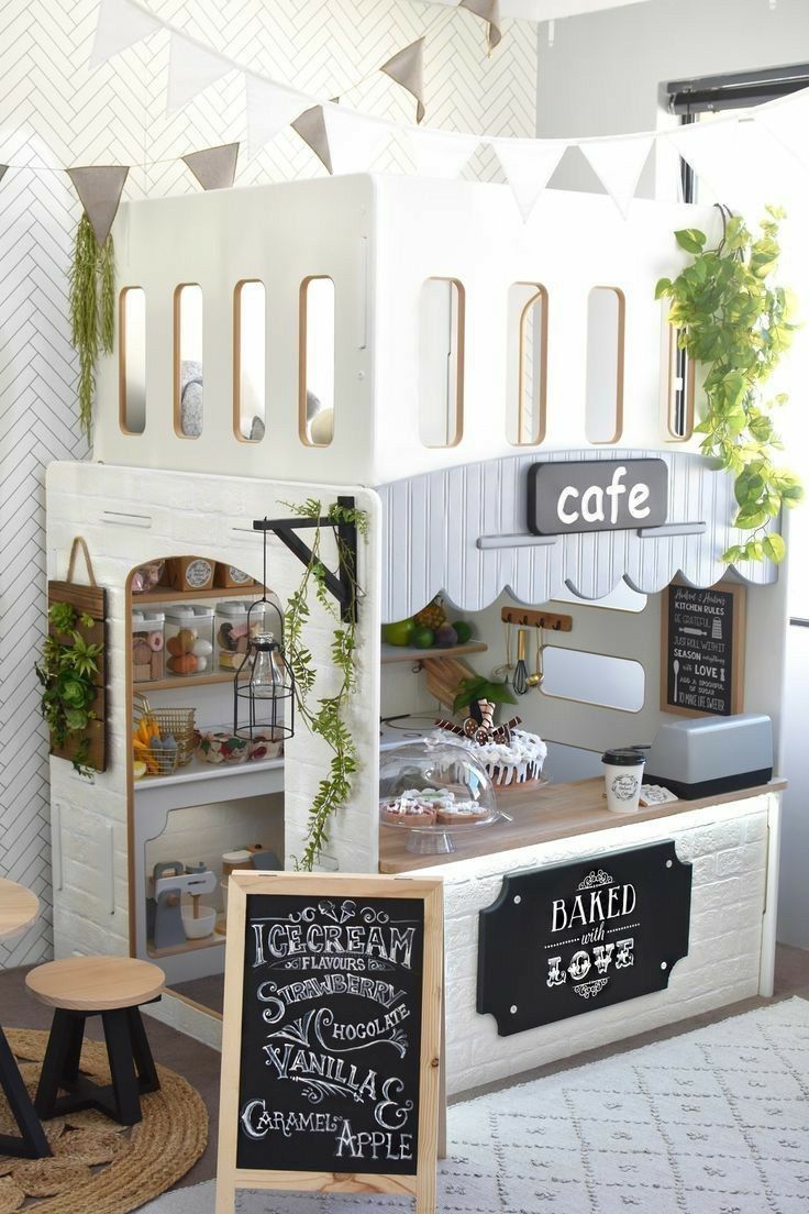 a miniature model of a cafe with chalkboard menus on the front and side