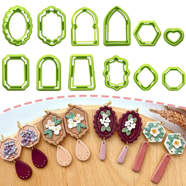 the cookie cutters are decorated with flowers and leaves, along with other items for making cookies