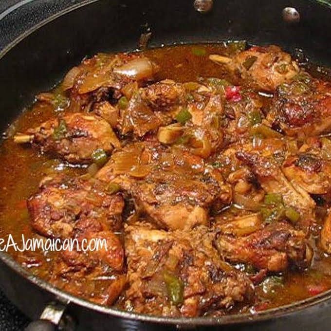 meat and vegetable stew in a skillet on the stove top, ready to be eaten