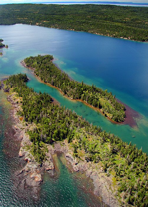 an island surrounded by water and trees