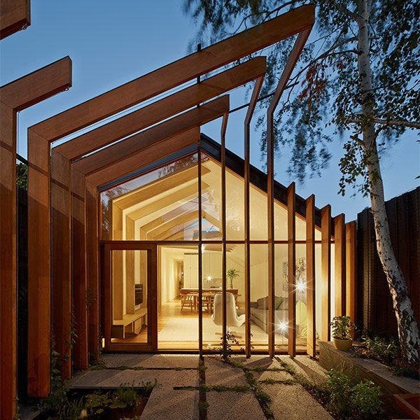 the entrance to a modern home at night