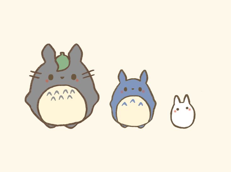 two totoro and an bunny sitting next to each other