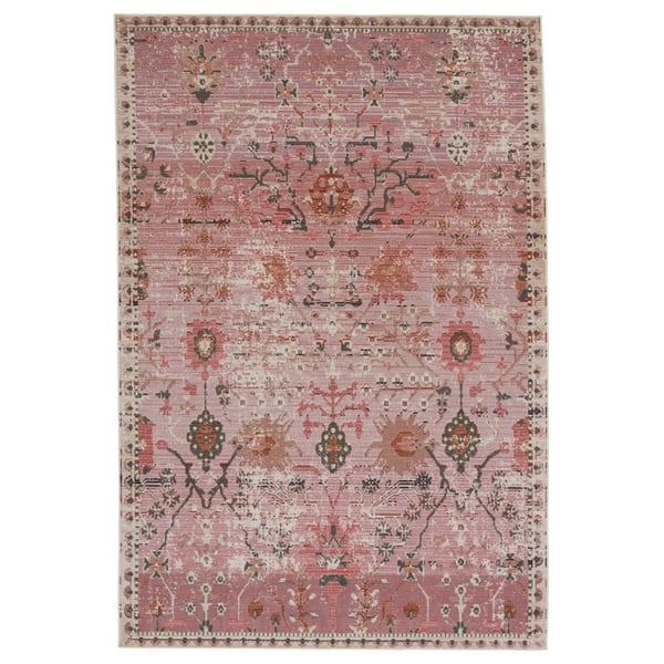 a pink rug with an ornate design on the front and back side, in various colors