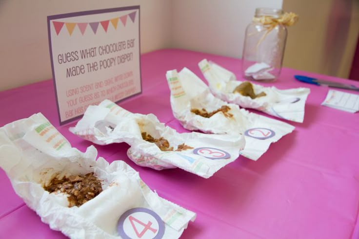 there are several pieces of food on the table with paper wrapper around it and a sign in the background