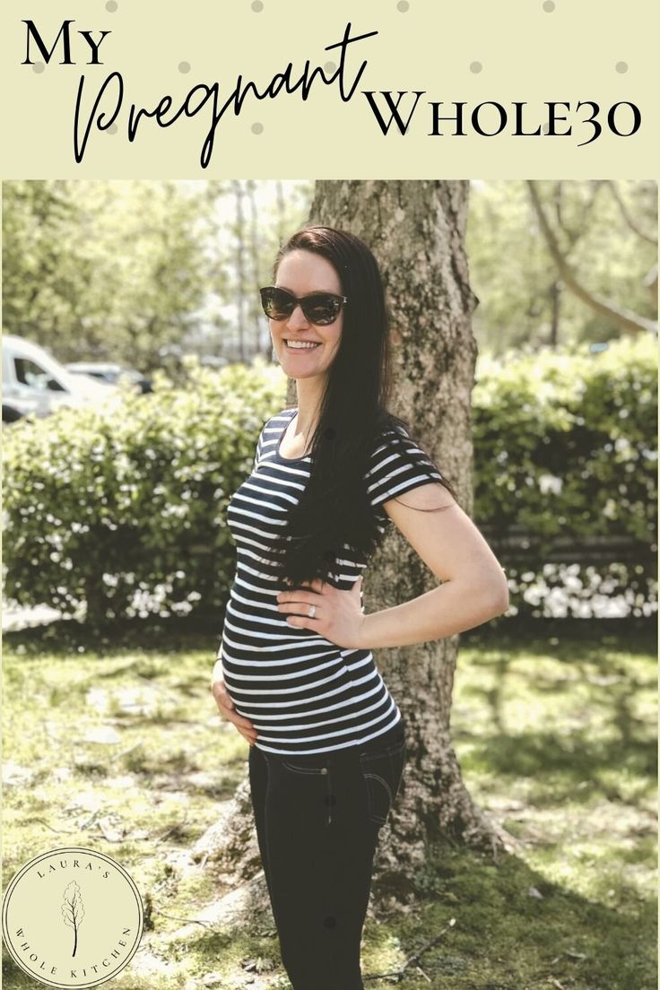 a woman standing in front of a tree with the words, my pregnant whole 30