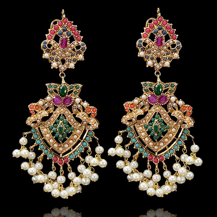 Imperial classics embodying the essence of celebration with richness of nauratan stones! Opt for opulence with stunning pair of earrings curated with breathtaking stone work and pearl moti emulating sheer class. Approximate earrings length is 3.5". Gold-plated on high-quality brass as base metal. Made by order. Kindly allow 5-7 weeks for the delivery of this item. For custom or urgent requests, please contact support@alacouture.com. *Please Note: The multi-colored beadwork might be slightly vary Festive Temple Jewelry Pearl Earrings With Stone Work, Festive Pearl Chandbali Bridal Earrings, Festive Chandbali Bridal Earrings With Pearls, Bollywood Chandbali Pearl Bridal Earrings, Elegant Kundan Pearl Earrings For Celebration, Elegant Pearl Chandbali Bridal Earrings With Tilla, Festive Pearl Chandbali Danglers, Bollywood Style Pearl Bridal Earrings For Festive Occasions, Elegant Pearl Earrings With Intricate Design For Diwali