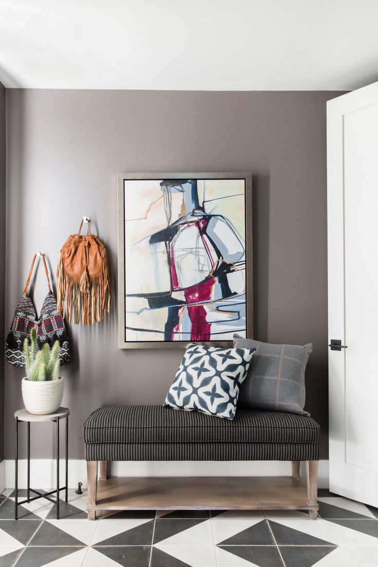 a black and white checkered floor in a living room with two paintings on the wall