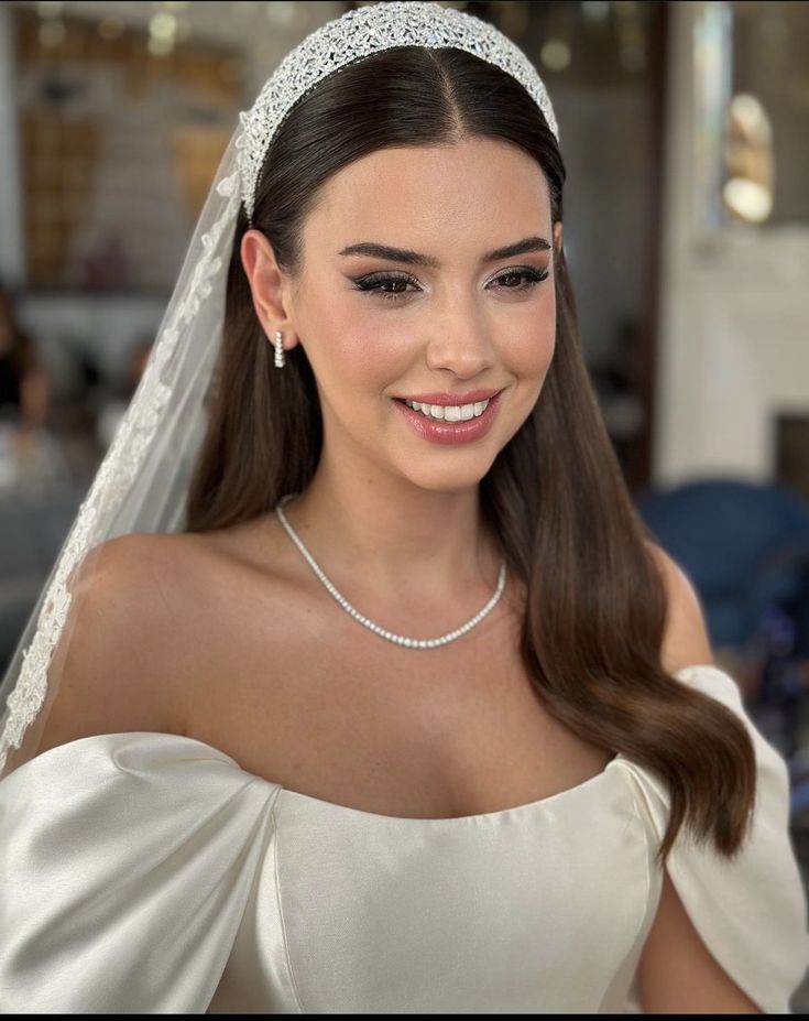 a woman wearing a tiara and smiling at the camera