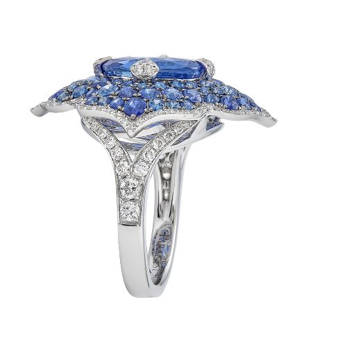 a ring with blue and white stones on it's sides, set in 18k white gold