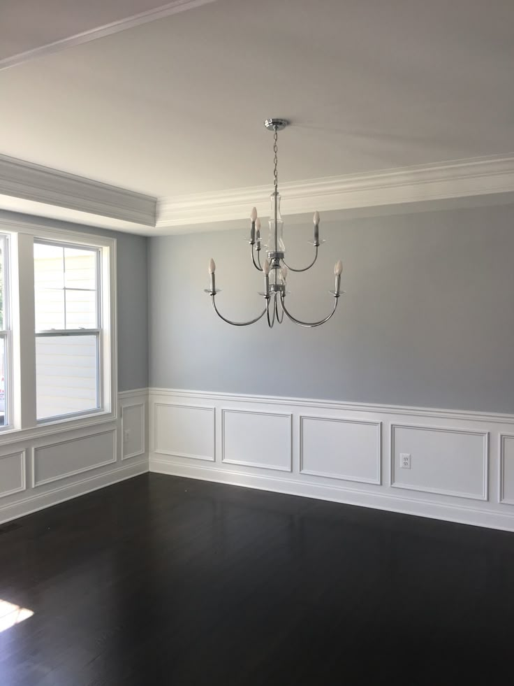 empty room with chandelier and hard wood flooring