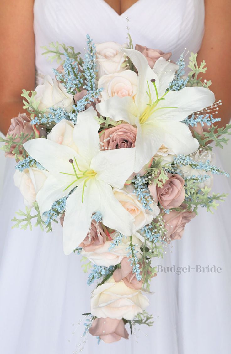 a bridal holding a bouquet of white and pink flowers