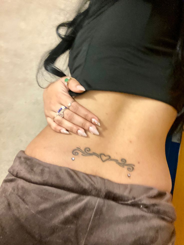 tramp stamp tattoo Back Pearcing, Mid Stomach Tattoo, Waistline Tattoos, But Tattoos For Women, Hamstring Tattoo, Cute Back Tattoos, Trampstamp Tattoo, 2006 Tattoo, Waist Tattoos