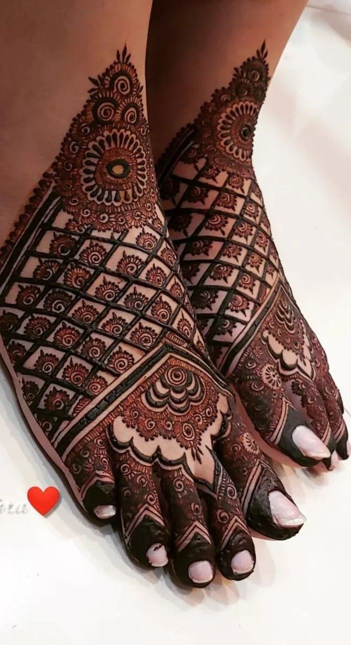 the feet are decorated with henna designs