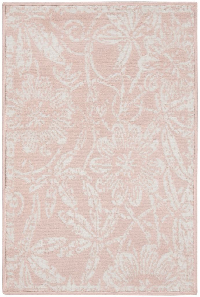 a pink rug with white flowers on it