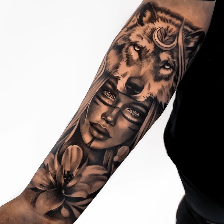 a woman's arm with an image of a wolf and two women on it