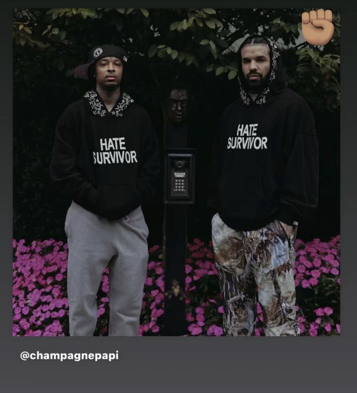 two men standing next to each other wearing matching sweatshirts with hate survivor written on them