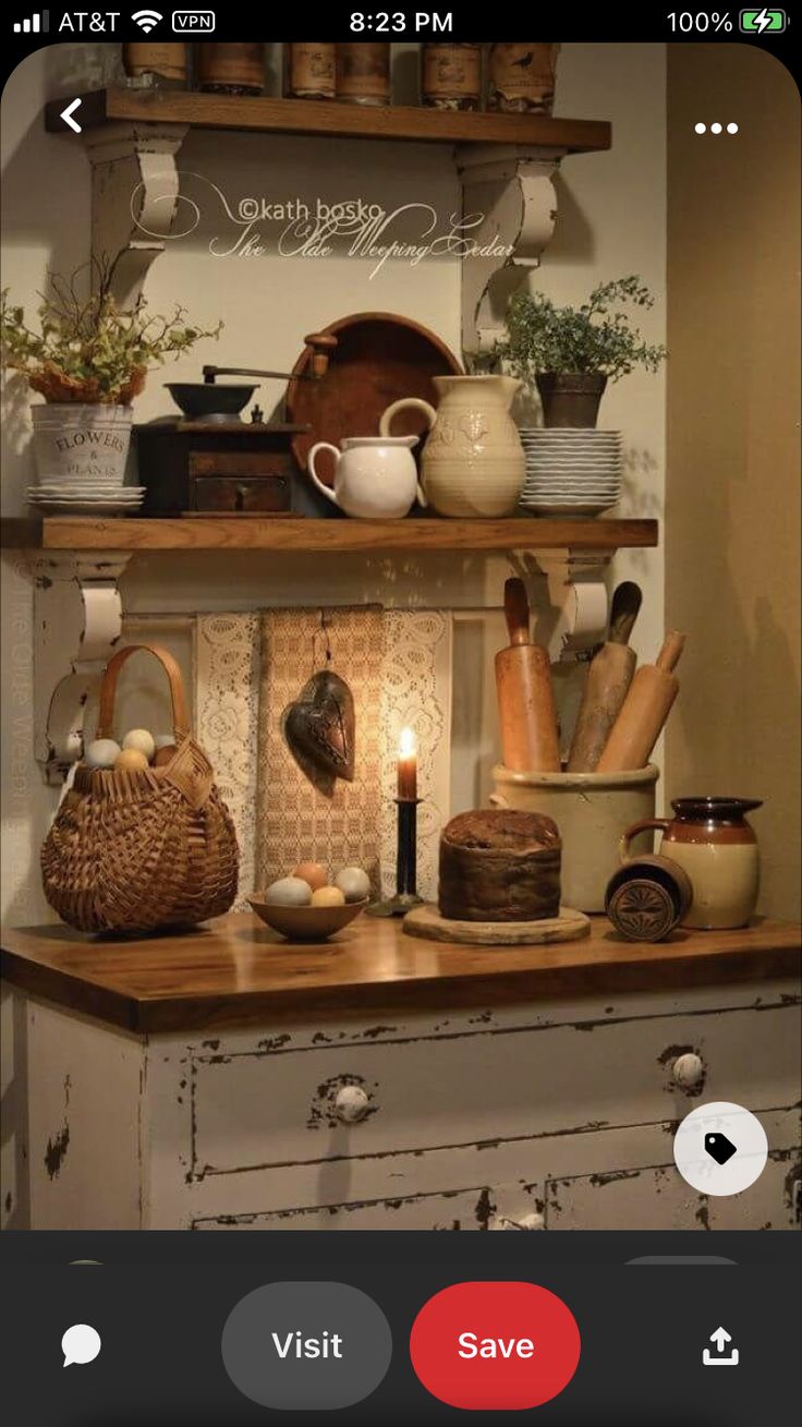 an old dresser with dishes on it and candles in the middle, next to other items