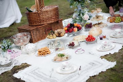 an outdoor picnic with food on the table