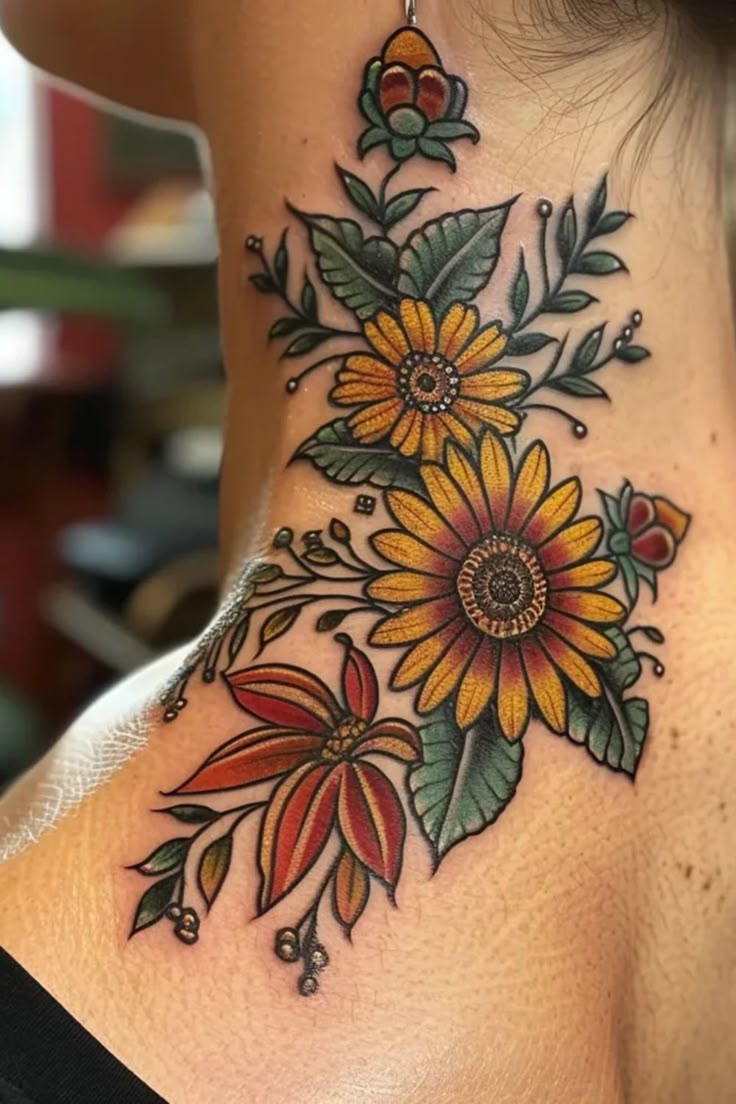 a woman's neck with sunflowers and leaves on it