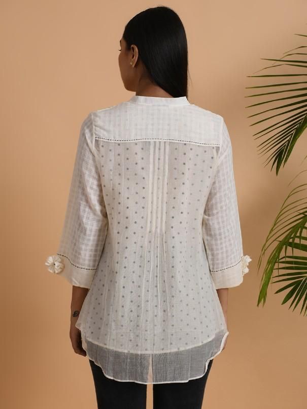 A cotton khadi & chanderi shirt with front placket, 3/4th sleeves, comes with a soft cotton matching slip. Garment measurements (in Inches): Size XS : Bust-34", Waist-36", Hip-Flared Size S : Bust-36", Waist-38", Hip-Flared Size M : Bust-38", Waist-40", Hip-Flared Size L : Bust-40", Waist-42", Hip-Flared Size XL : Bust-42", Waist-44", Hip-Flared Size XXL : Bust-44", Waist-46", Hip-Flared Size 3XL : Bust-46", Waist-48", Hip-Flared Size 4XL : Bust-48", Waist-50", Hip-Flared Length: 30-32", sle Off White Cotton Kurta With Printed Motifs, Spring Cotton Kurta With Pintucks, Spring Long Sleeve Kurta With Pintucks, Spring Long Sleeve Pintuck Kurta, White Handloom Cotton Kurta, Cotton Straight Kurta With Pintucks, Cotton Blouse With 3/4 Sleeves For Daywear, Summer Handloom Long Sleeve Kurta, Festive White Cotton Shirt