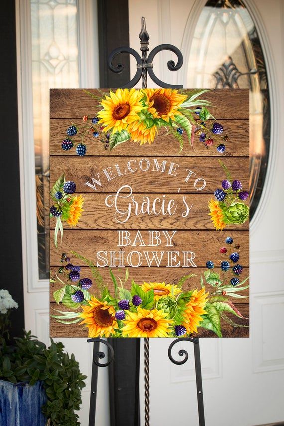 a welcome sign with sunflowers on it