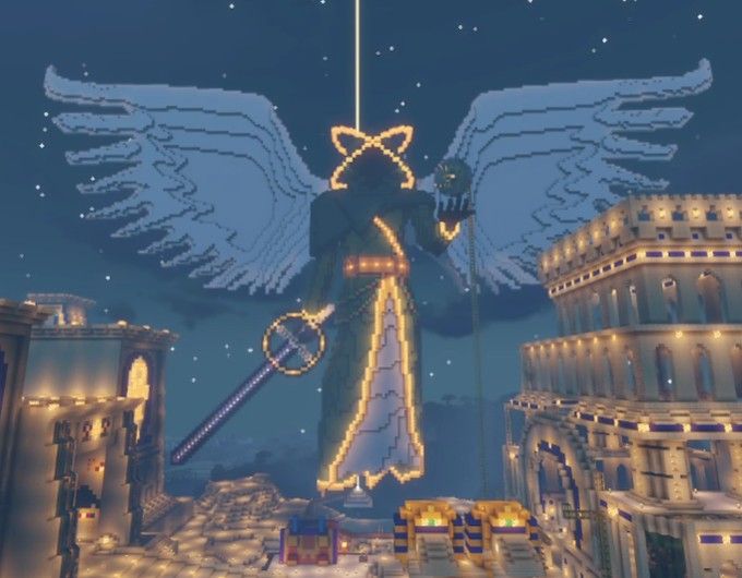 an angel statue in the middle of a city at night with lights on it's wings