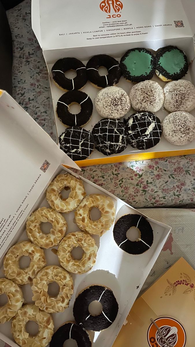 a box filled with lots of different types of donuts on top of a table